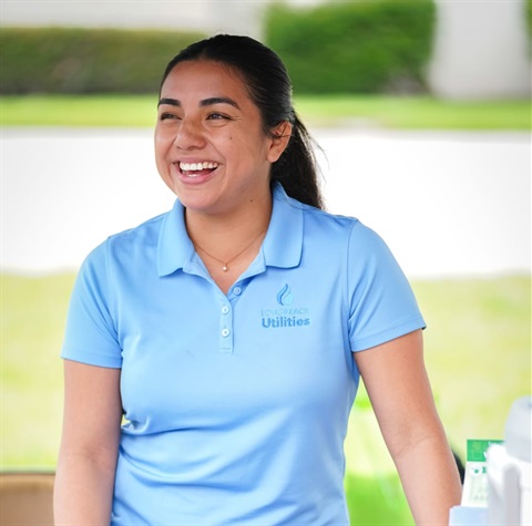 Woman in light blue Long Beach Utilies polo shirt smiling